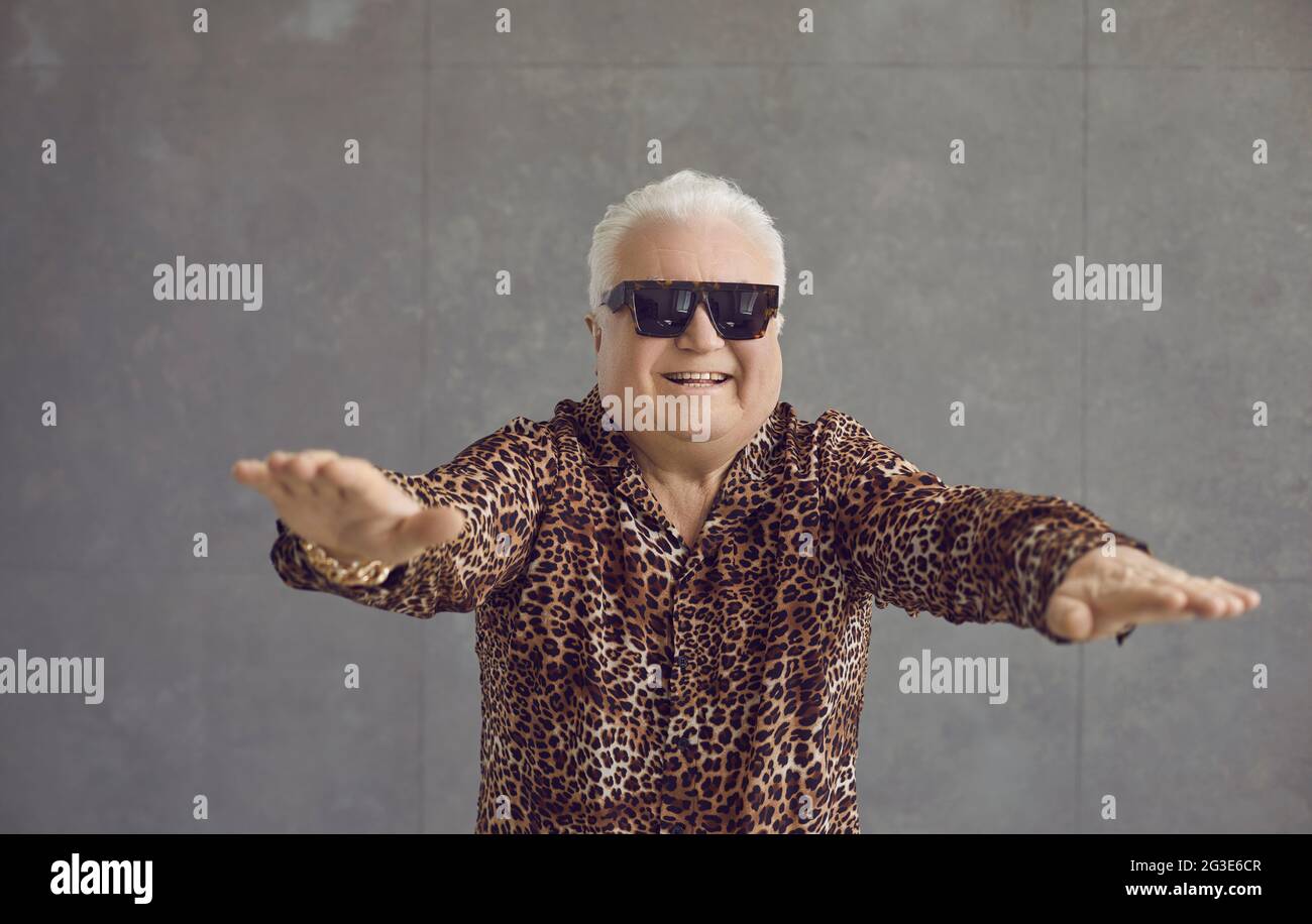 Studio portrait of a funny happy rich chubby pensioner enjoying an active fitness workout Stock Photo