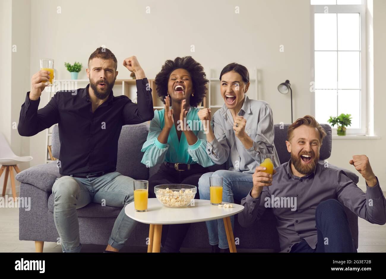 Multiethnic Fans Watching Soccer On TV And Screaming Celebrating 
