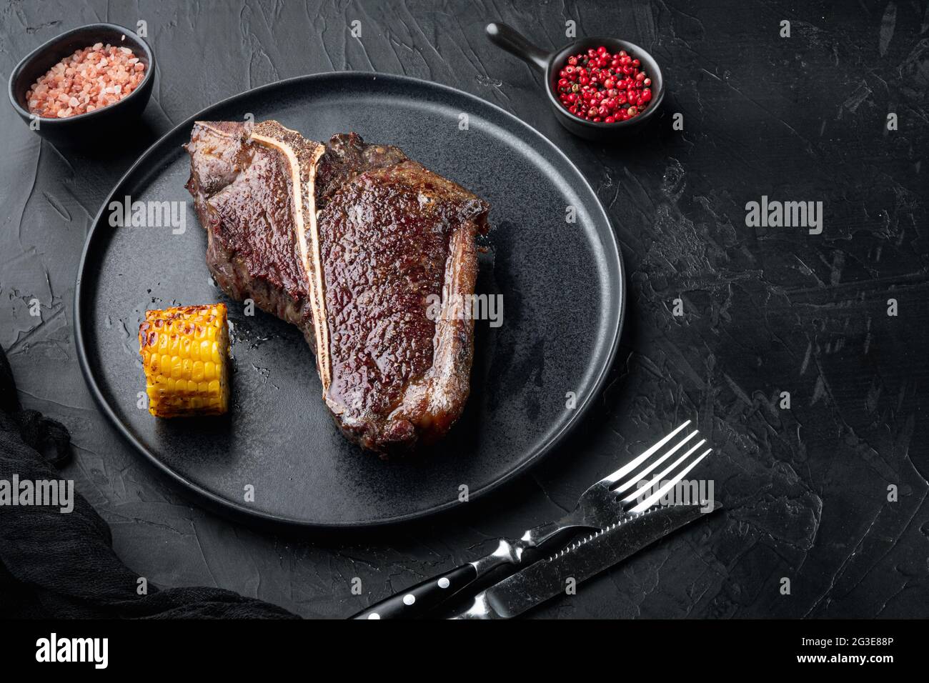 Aged Beef T Bone steak. Juicy cooked steak with rosemary and spices set