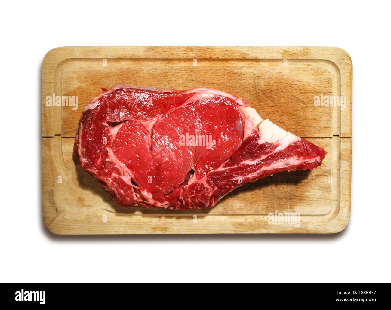 Raw beef prime rib on a cutting board isolated on white background