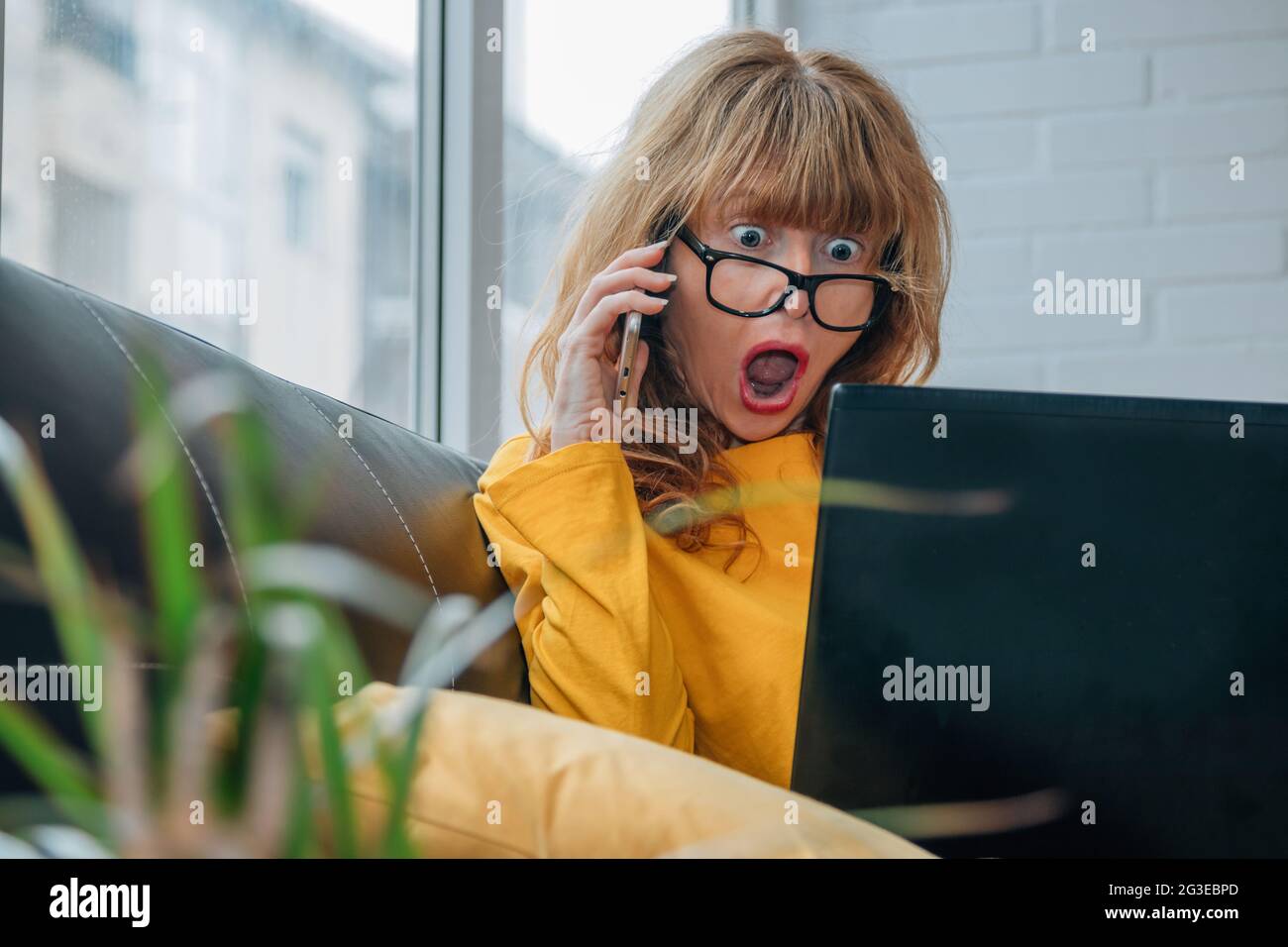 surprised woman looking at computer Stock Photo