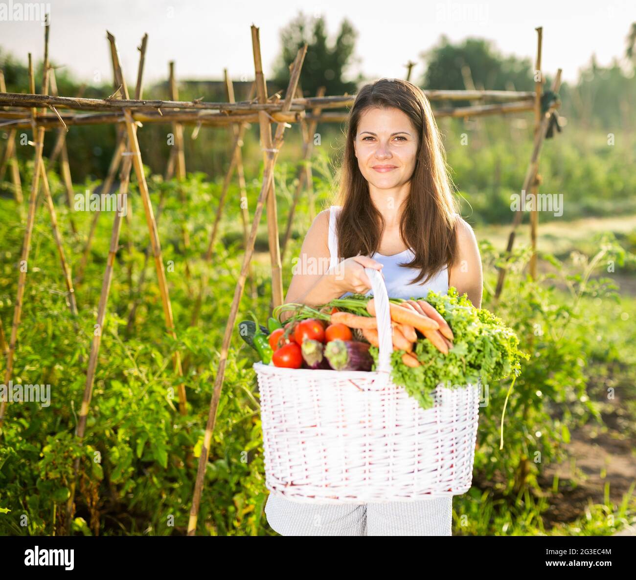 Woman posing in garden with harvested vegetables Stock Photo - Alamy