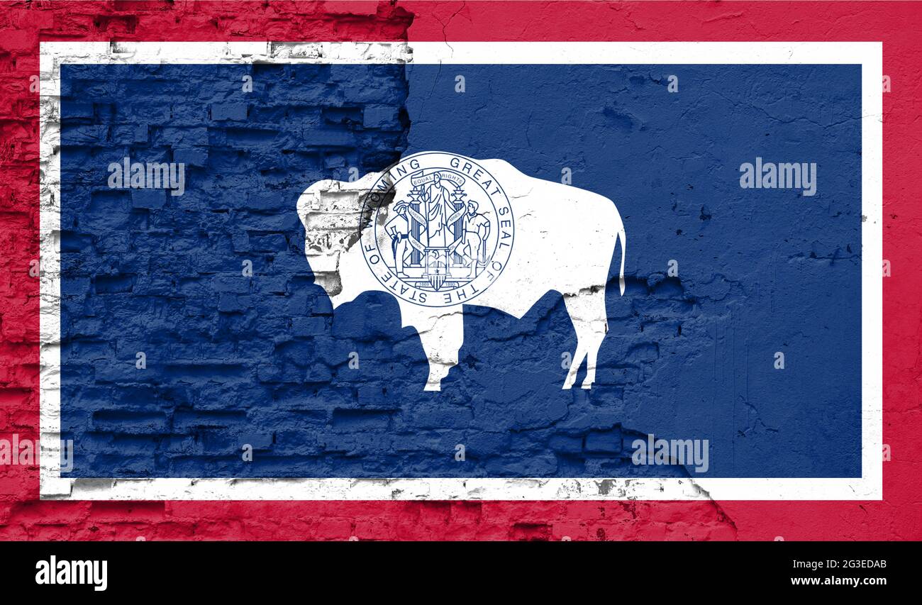 State of Wyoming flag is painted onto an old brick wall Stock Photo