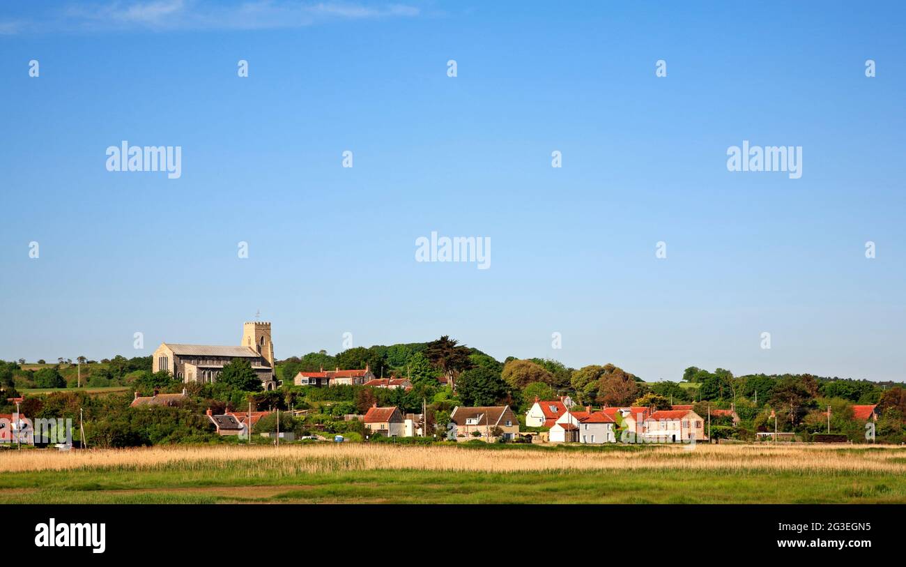 A view of the parish Church of St Nicholas and Salthouse village by the A149 coast road in North Norfolk at Salthouse, Norfolk, England, UK. Stock Photo