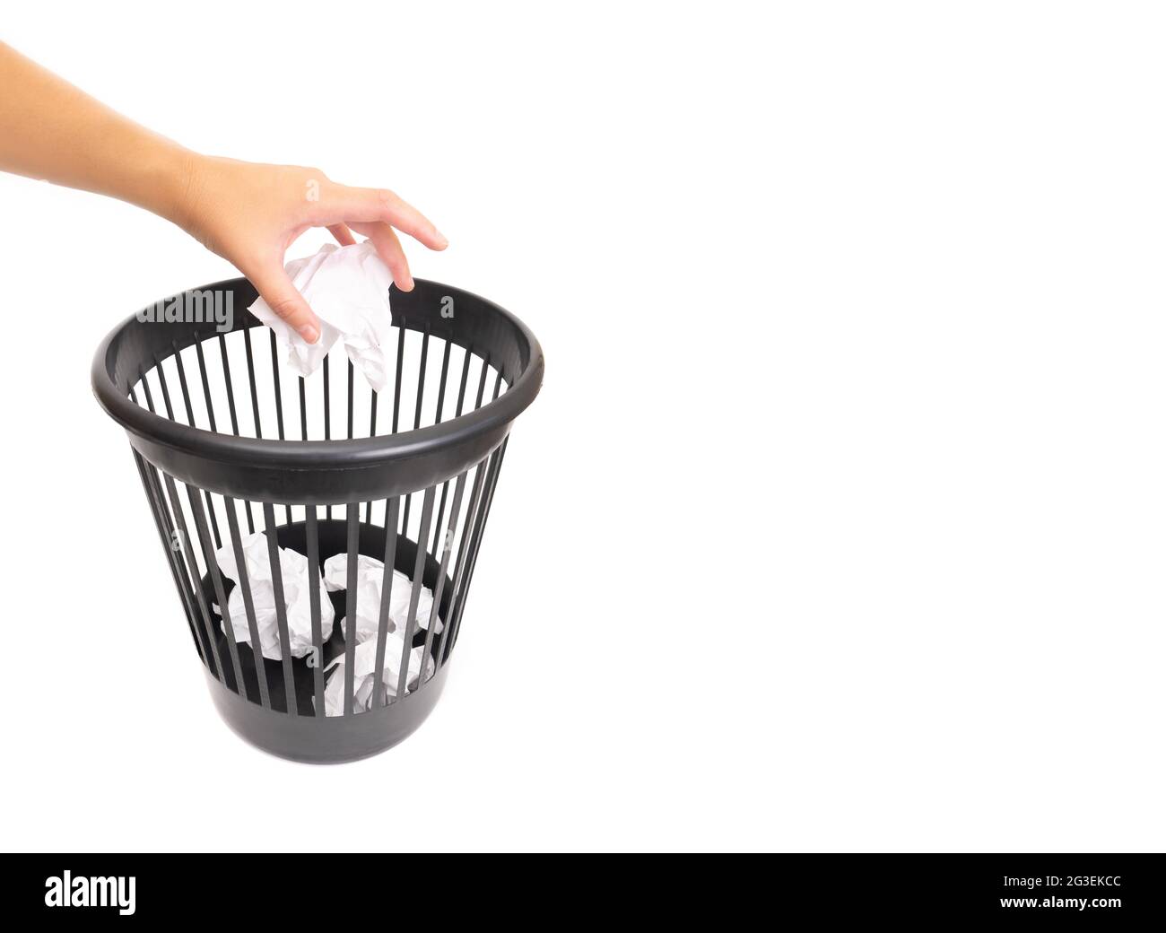 Female hand throwing a crumpled paper ball in a waste bin isolated on white Stock Photo