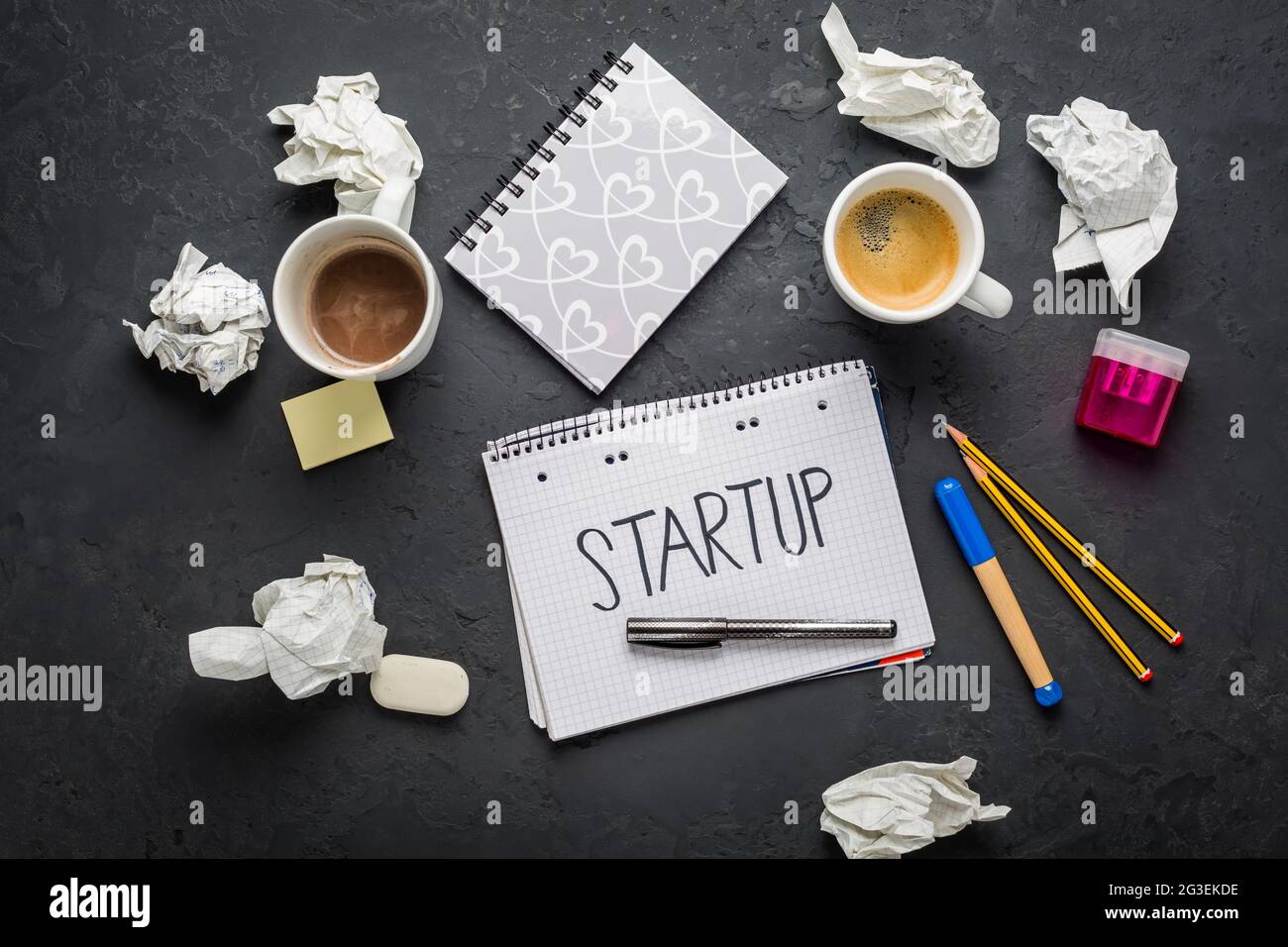 Startup concept - Notepad, coffee, discarded ideas and writing tools on ...