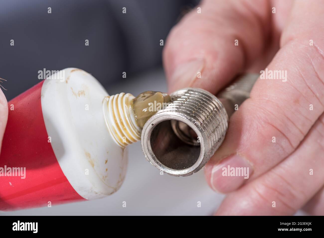 Plumber putting sealing paste on a thread, closeup Stock Photo Alamy