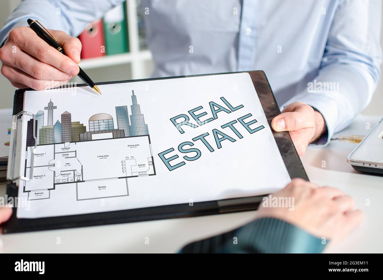Businessman showing real estate concept on a clipboard Stock Photo - Alamy