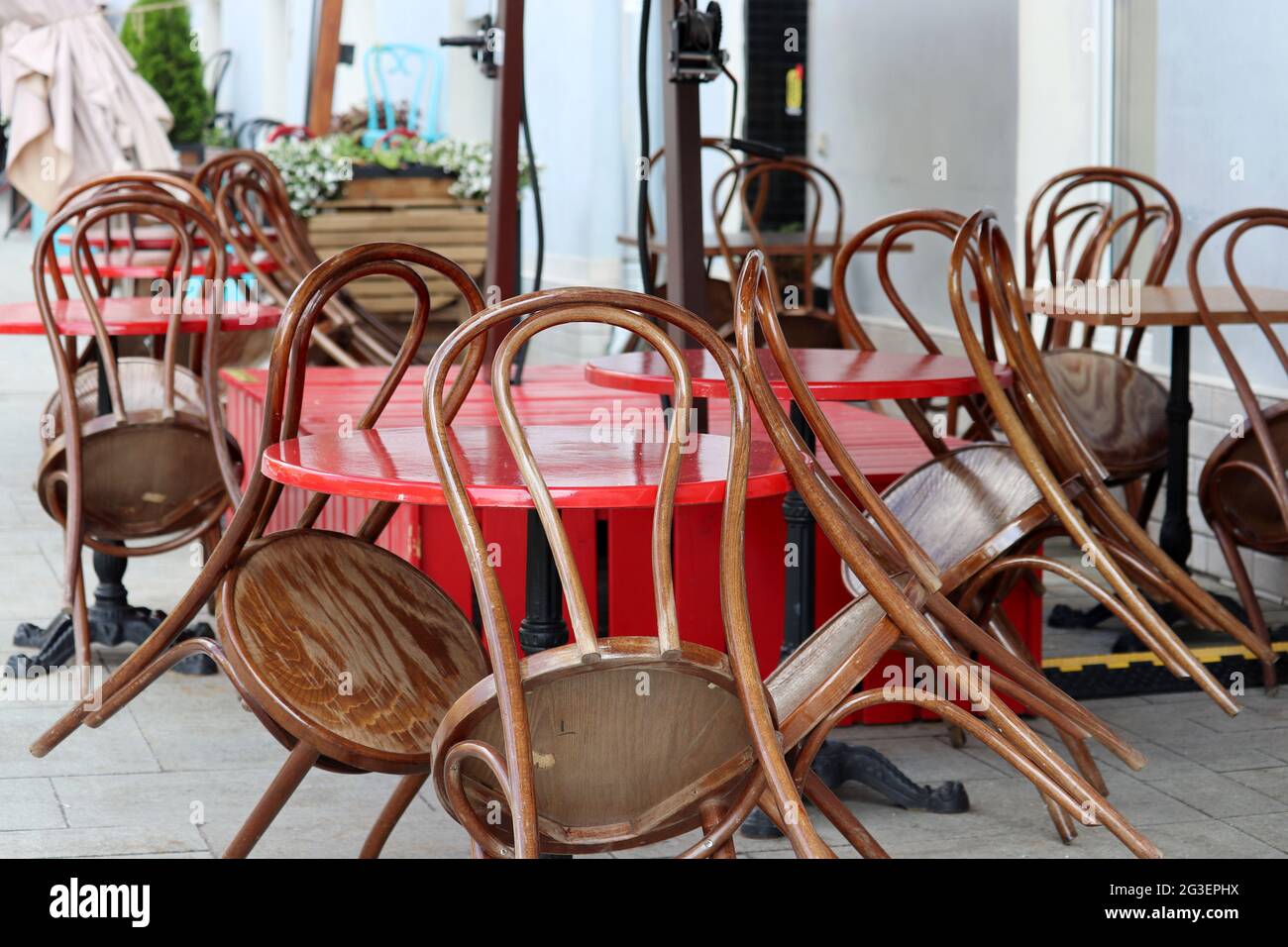 Street cafe with empty tables and folded chairs outdoor, city during ...