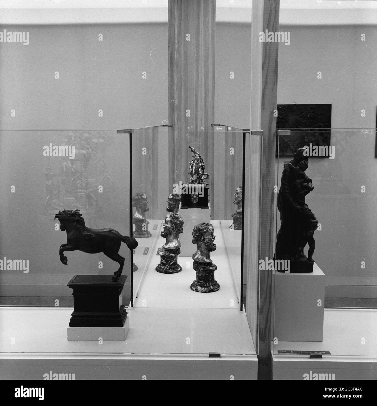 Room with two images on either side of a display case with grotesque ...