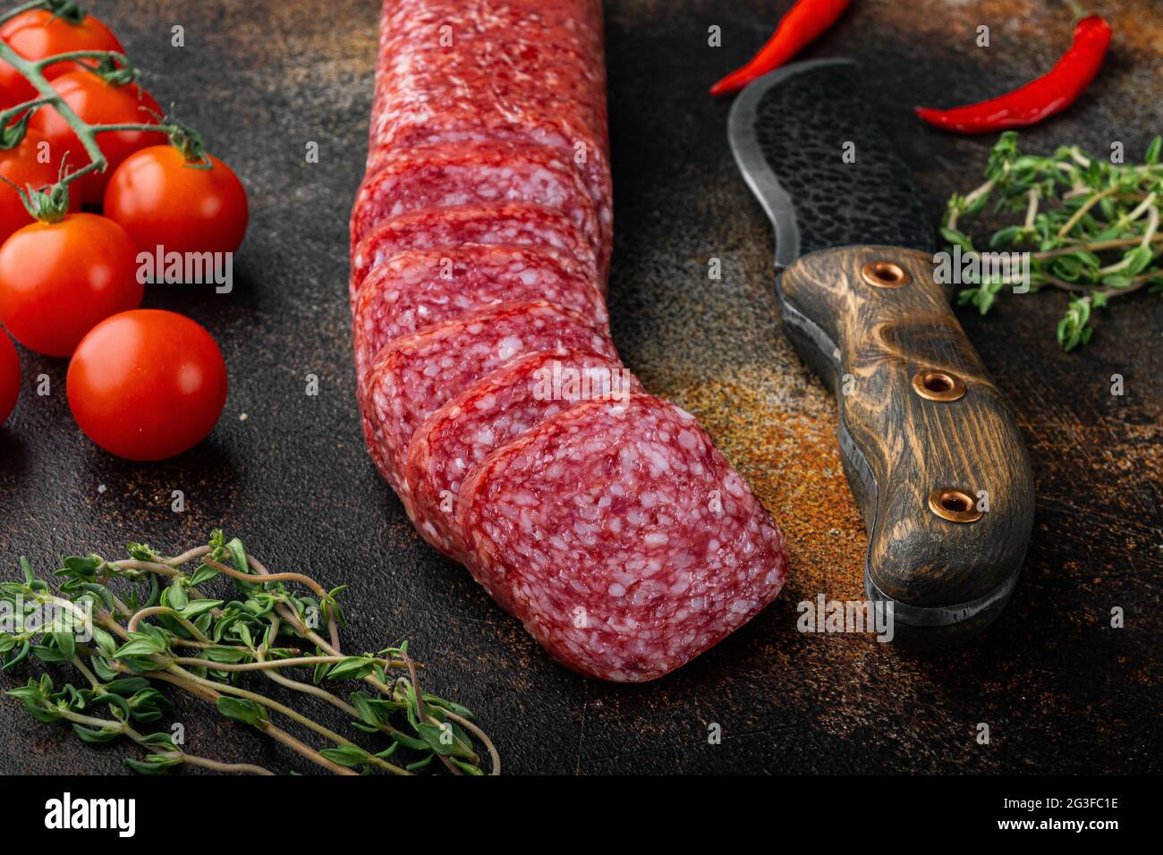 Salami, salami smoked sausage, sliced set, on old dark rustic table ...