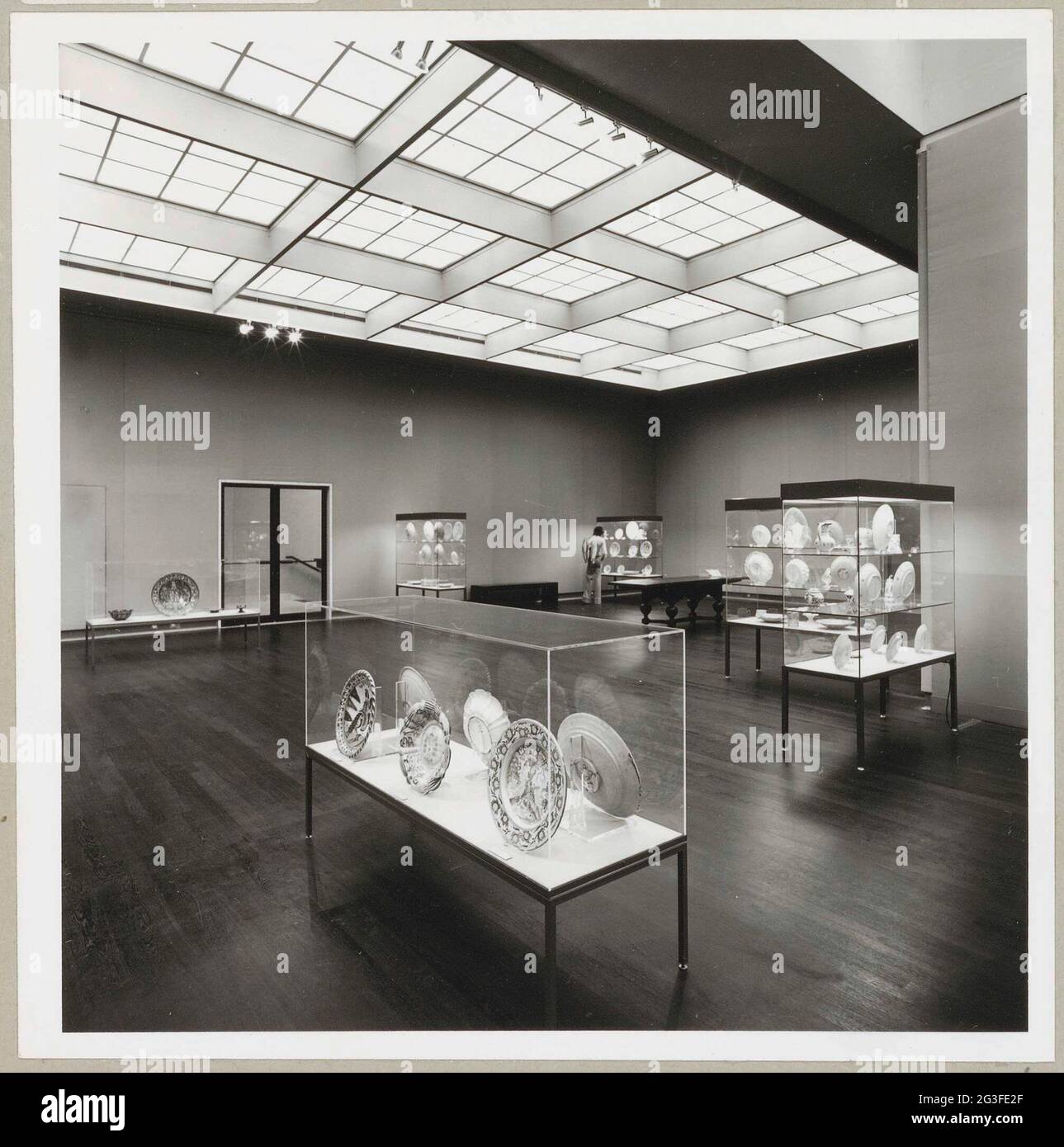 Room with various objects in showcases, a table and a passage to a ...