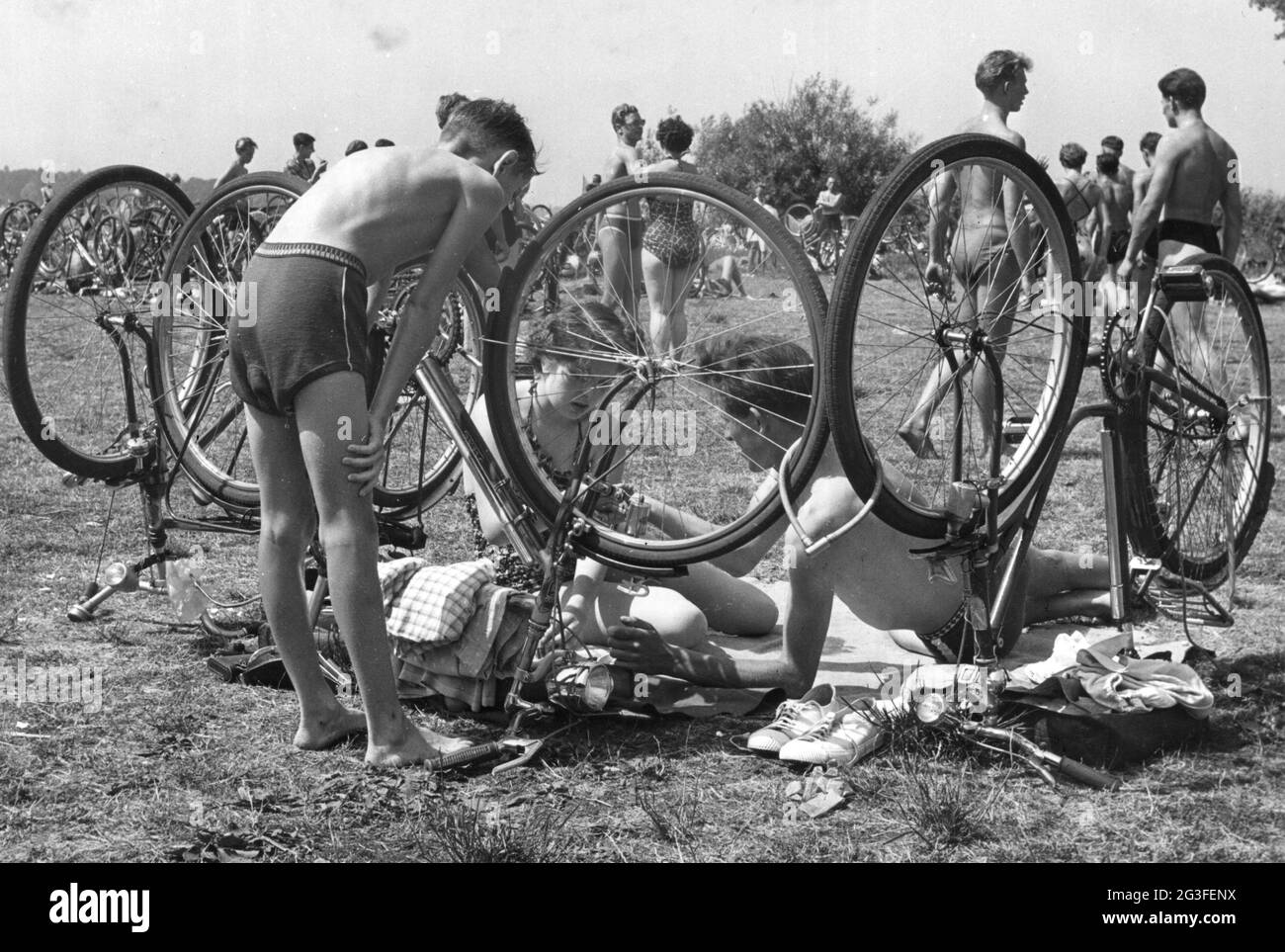 leisure time, lawn at lake, couple behind upside down bicycles lying on blanket, Berlin, Germany, ADDITIONAL-RIGHTS-CLEARANCE-INFO-NOT-AVAILABLE Stock Photo