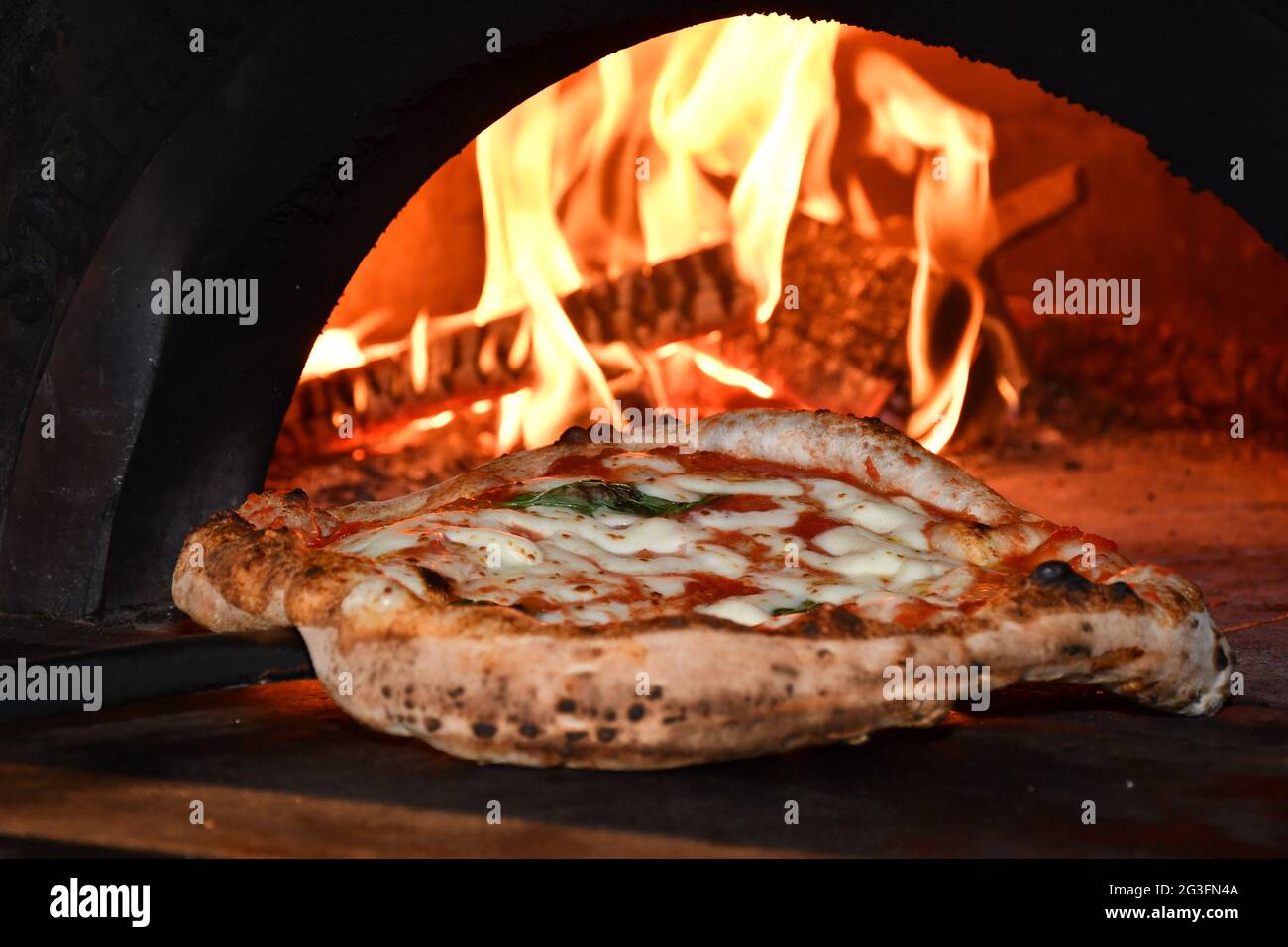 Taking pizza out of oven hires stock photography and images Alamy