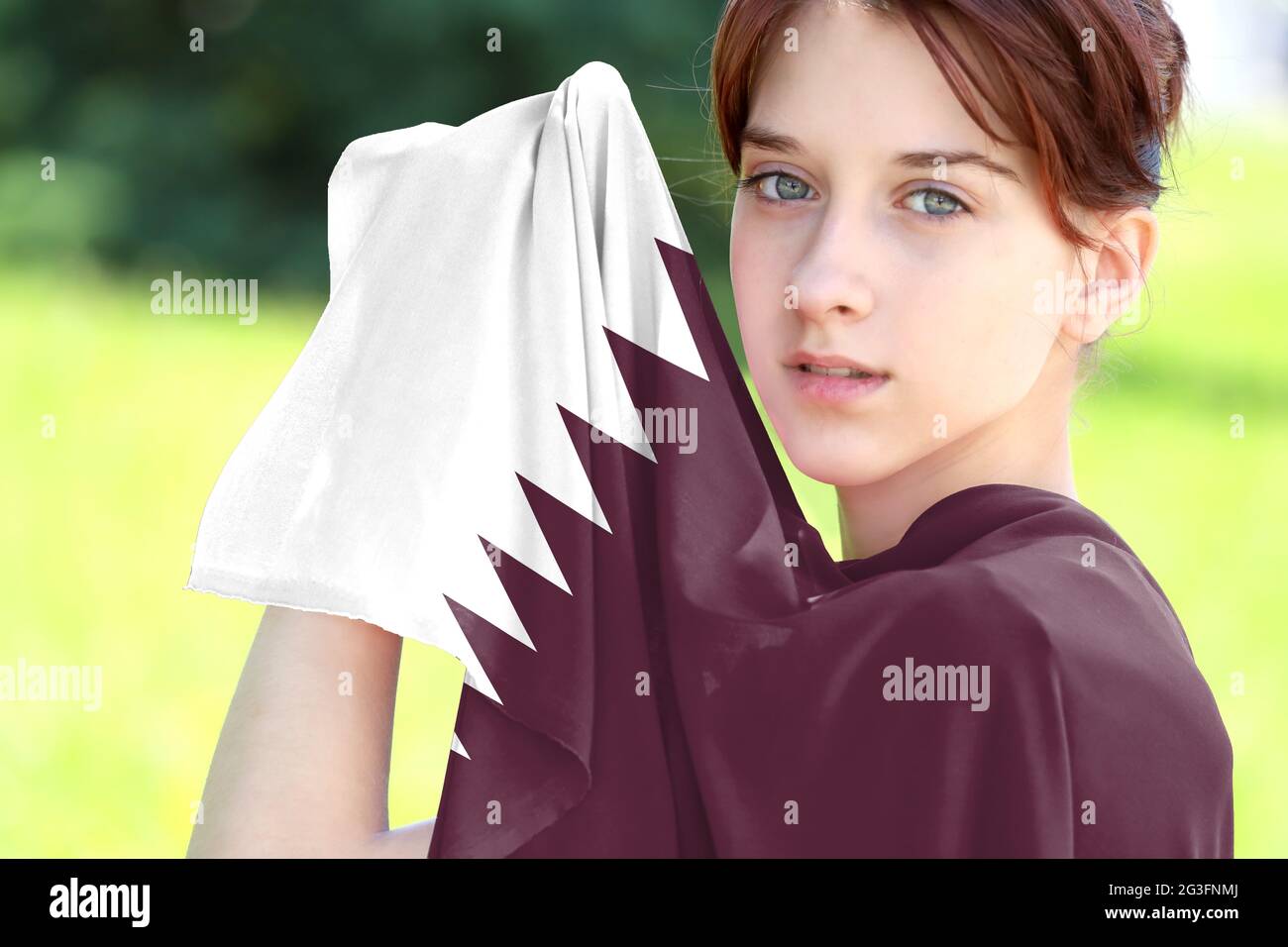 Young girl holding the flag of Qatar close up Stock Photo Alamy
