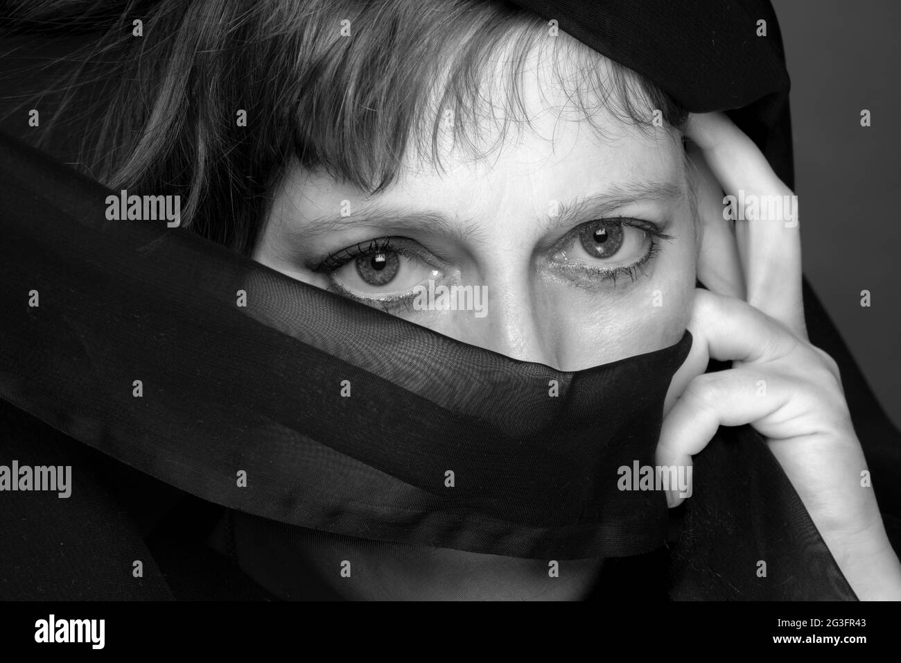Woman with face covering Stock Photo