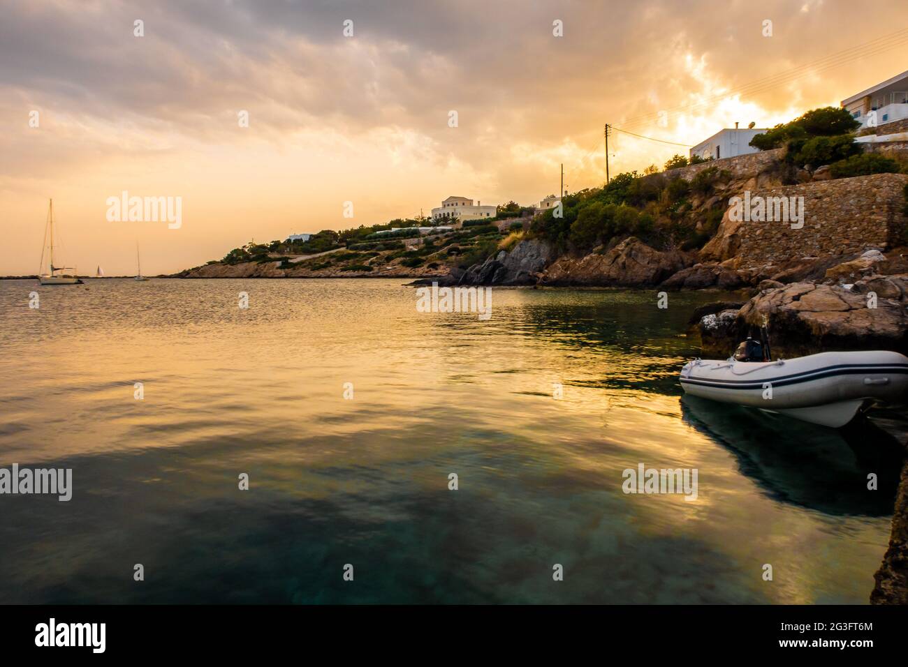 Sunset in Finikas Port on Siros Island, Greece, with sailing boats