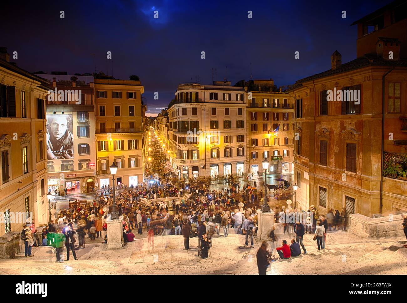ROME - NOV 3: People climb the spanish steps of Piazza di Spagna on the evening of November 3, 2012 in Rome. The 'scalinata' is Stock Photo