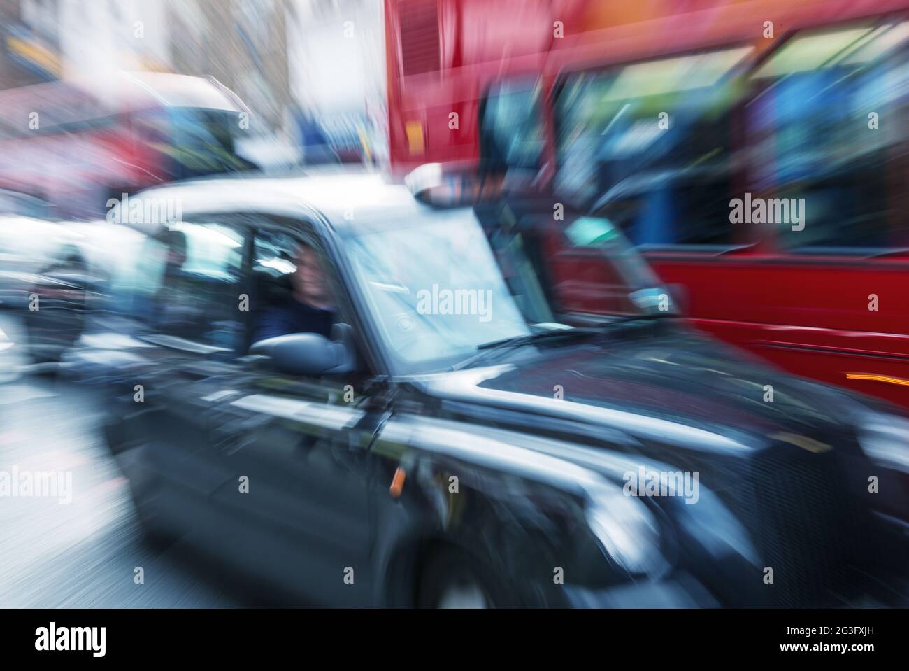 Motion blur picture of Black Cab and Red Double Decker Bus in the heart of London Stock Photo