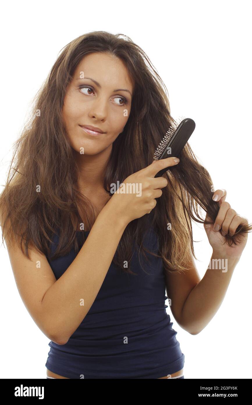 Pretty woman tries to detangle her hairs Stock Photo - Alamy