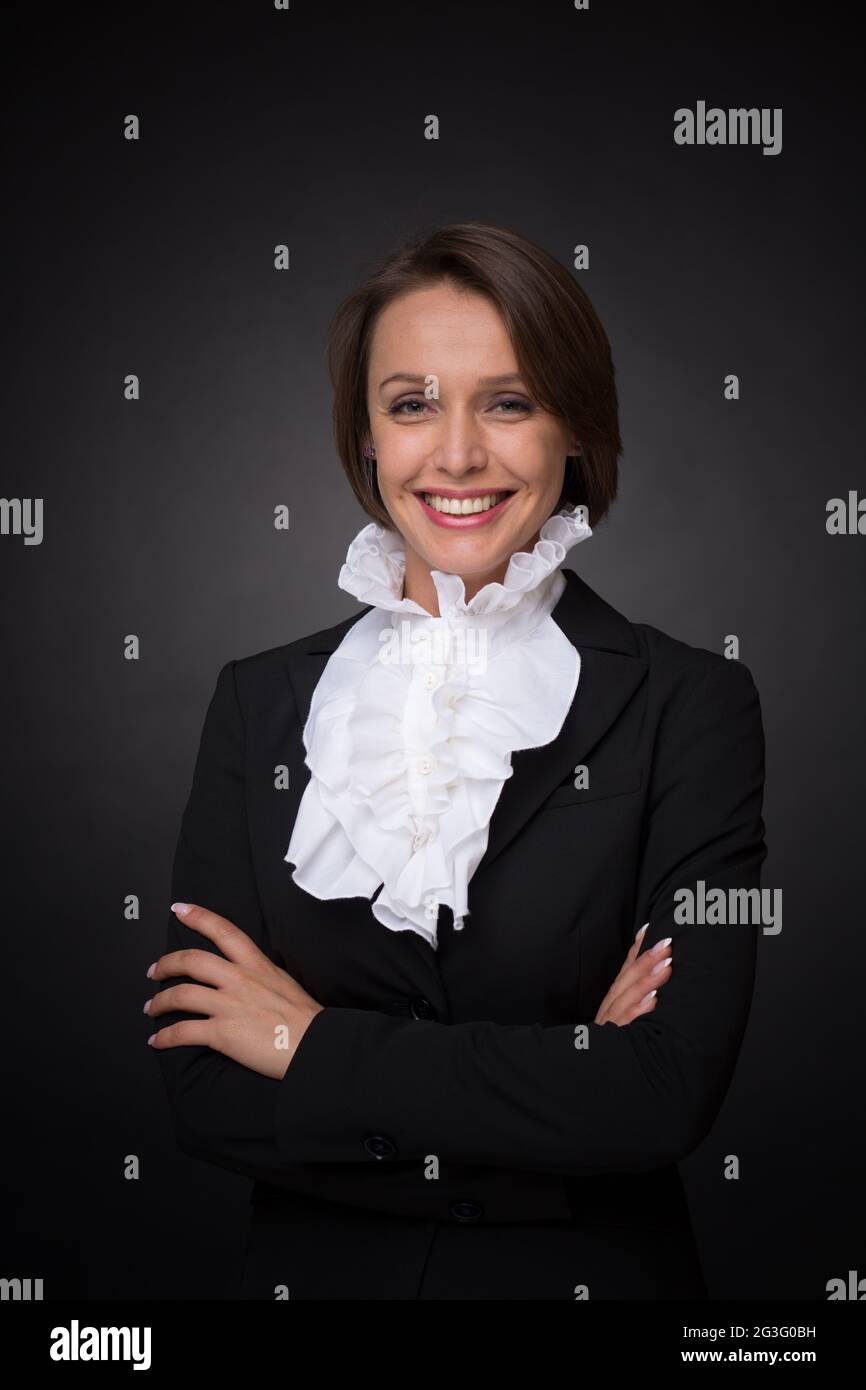 Business woman on dark grey background Stock Photo - Alamy