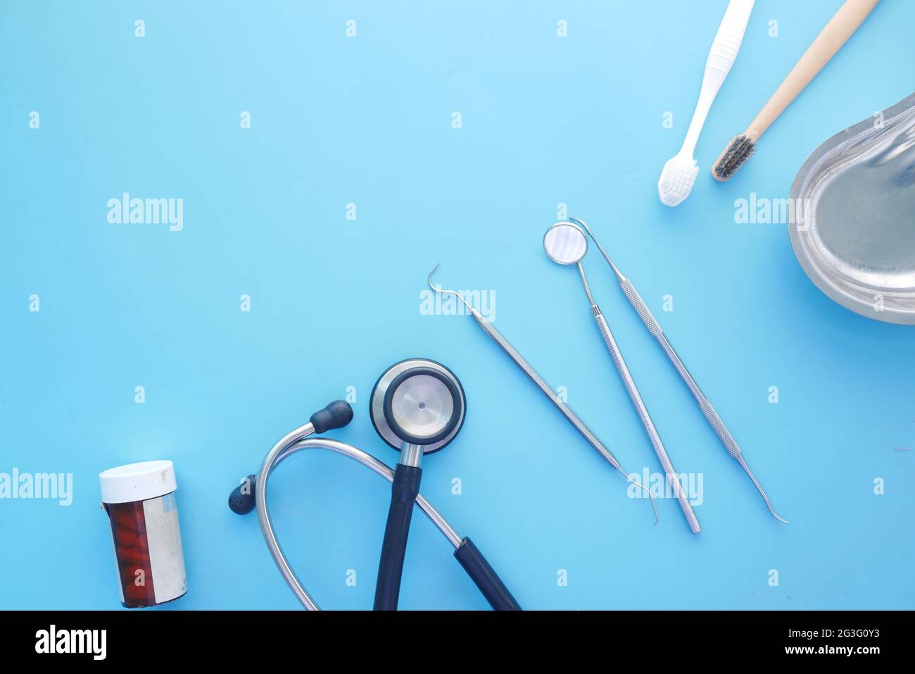 dental equipment , stethoscope and pill container on blue  Stock Photo