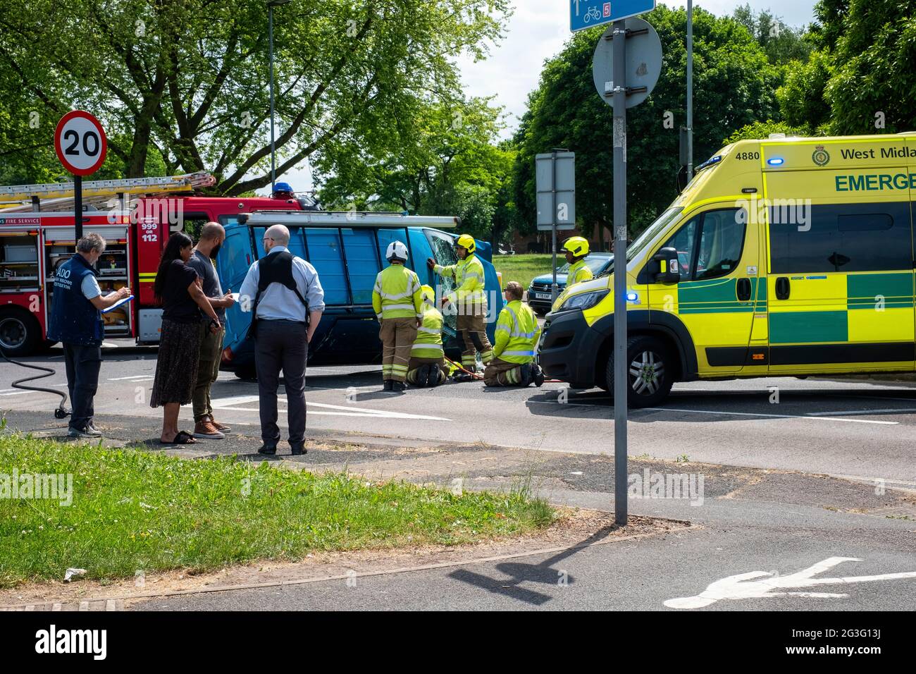 Emergency services block off road due to accident involving overturned van. Stock Photo
