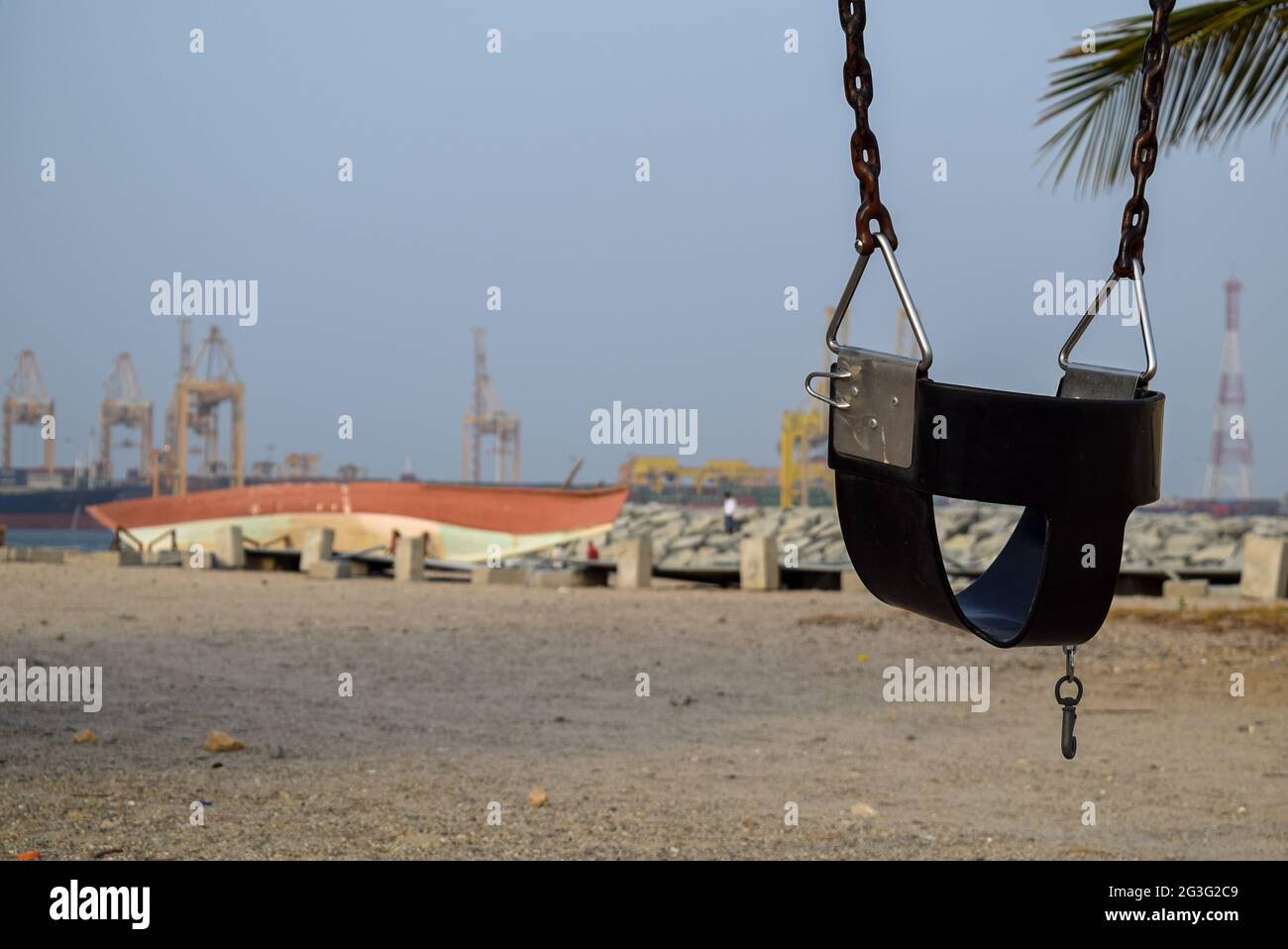 Baby swing seat on the beach in the Fujairah, UAE. Stock Photo