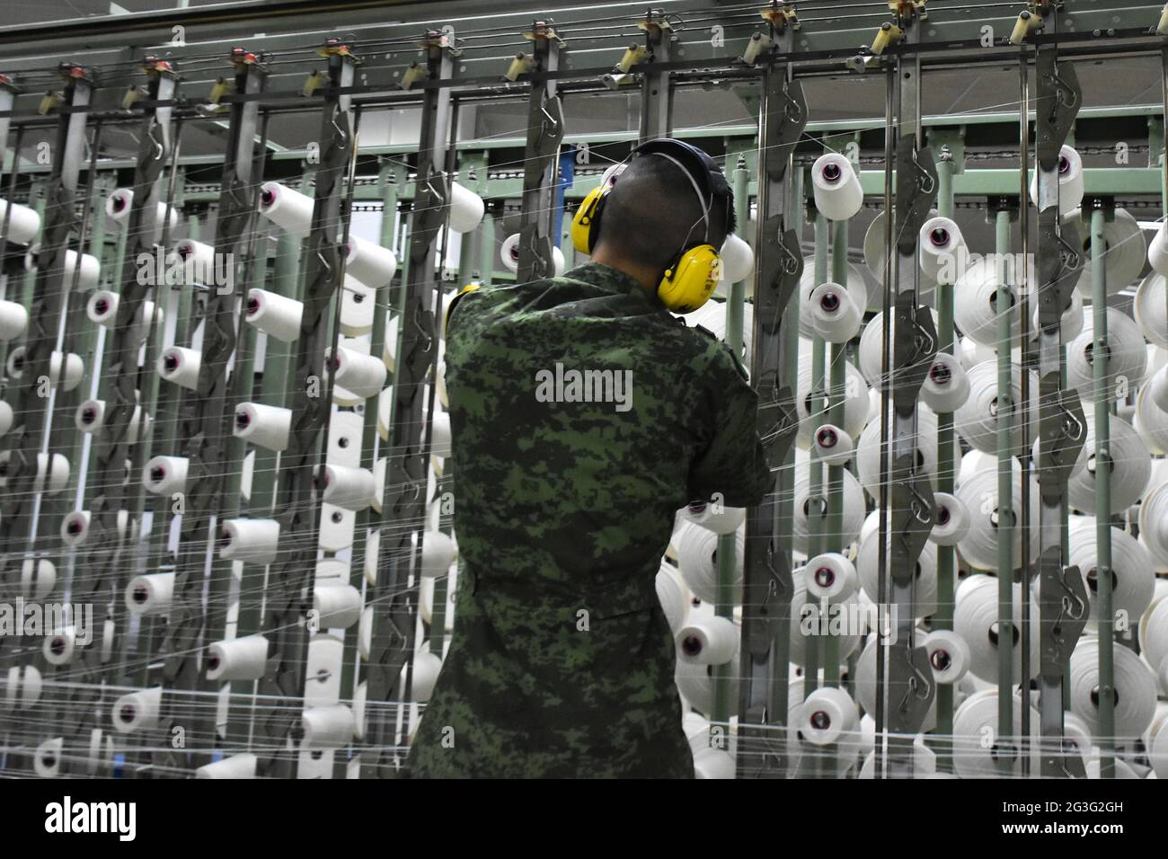 A military worker manufactures uniforms for members of Mexican Army at