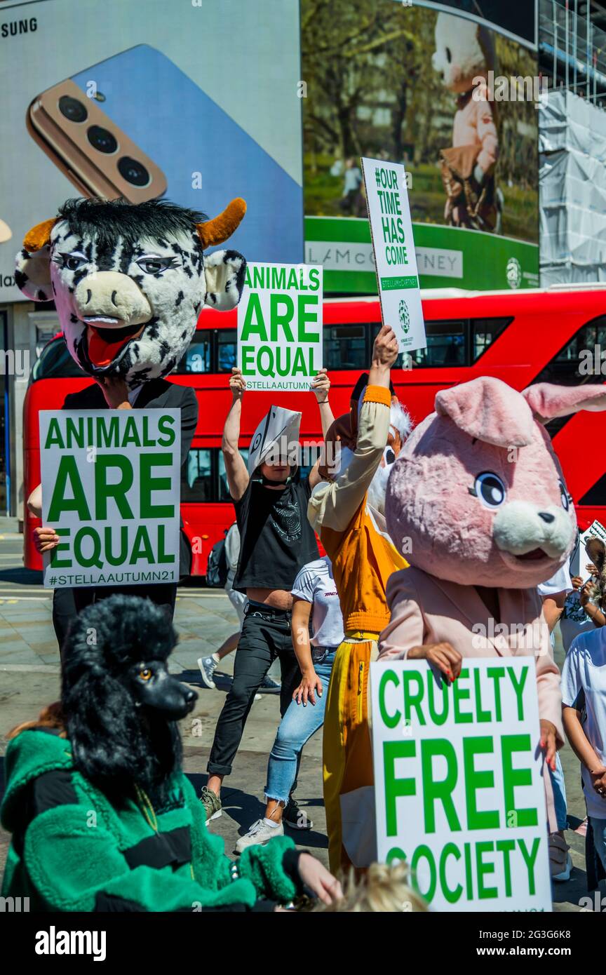 London, UK. 16th June, 2021. Stella McCartney's Autumn 2021 campaign, ‘Our time has come' on the Piccadilly Lights, Piccadilly Circus. To encourage people to sign the HSI Fur Free Britain petition, Stella McCartney organised a guerrilla gathering with brand ambassadors (approx 20 - 30) wearing animal heads similar to those used in the Autumn 2021 campaign, asking passers-by to sign the Humane Society Fur Free Britain petition. Credit: Guy Bell/Alamy Live News Stock Photo