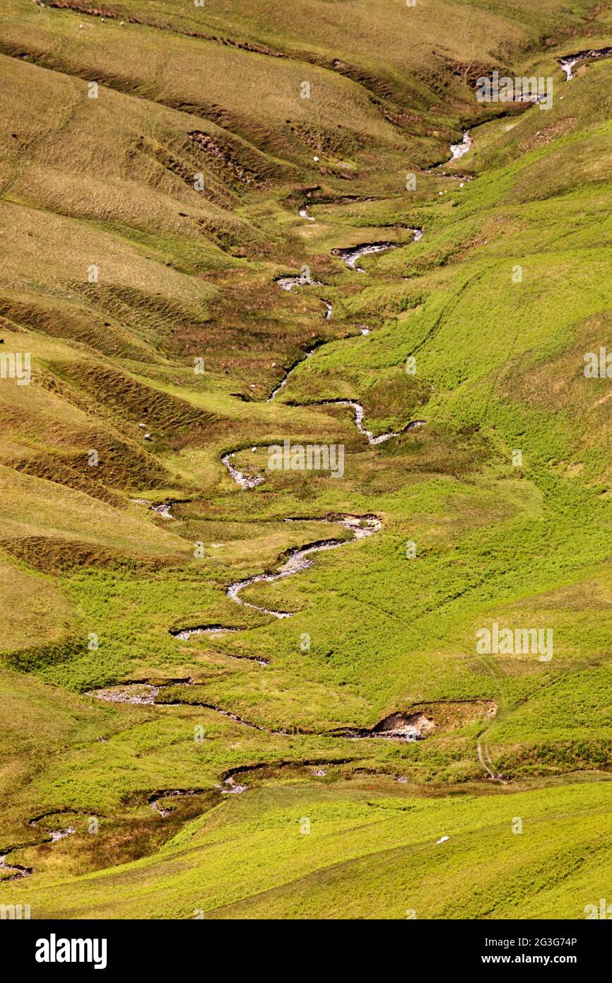 Meandering stream on a hillside above Sedbergh in Cumbria, England. Sedbergh is in the Yorkshire Dales National Park. Stock Photo