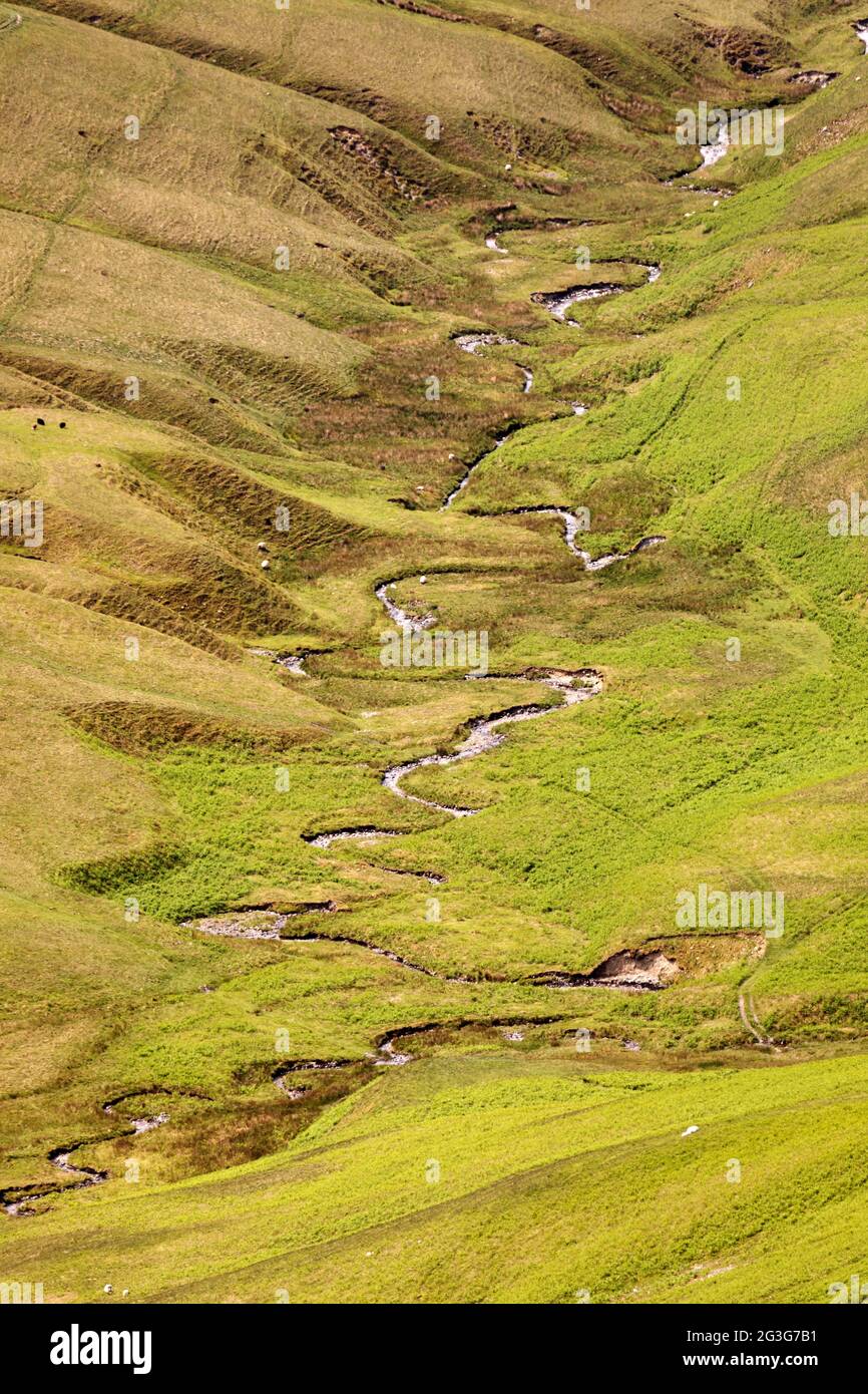 Meandering stream on a hillside above Sedbergh in Cumbria, England. Sedbergh is in the Yorkshire Dales National Park. Stock Photo