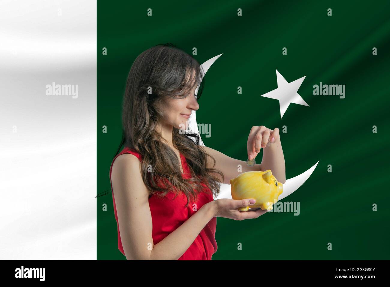 Economy in Pakistan. Accumulating and saving money in Pakistan. Woman putting money coin in piggy bank for saving money and plan finance Stock Photo