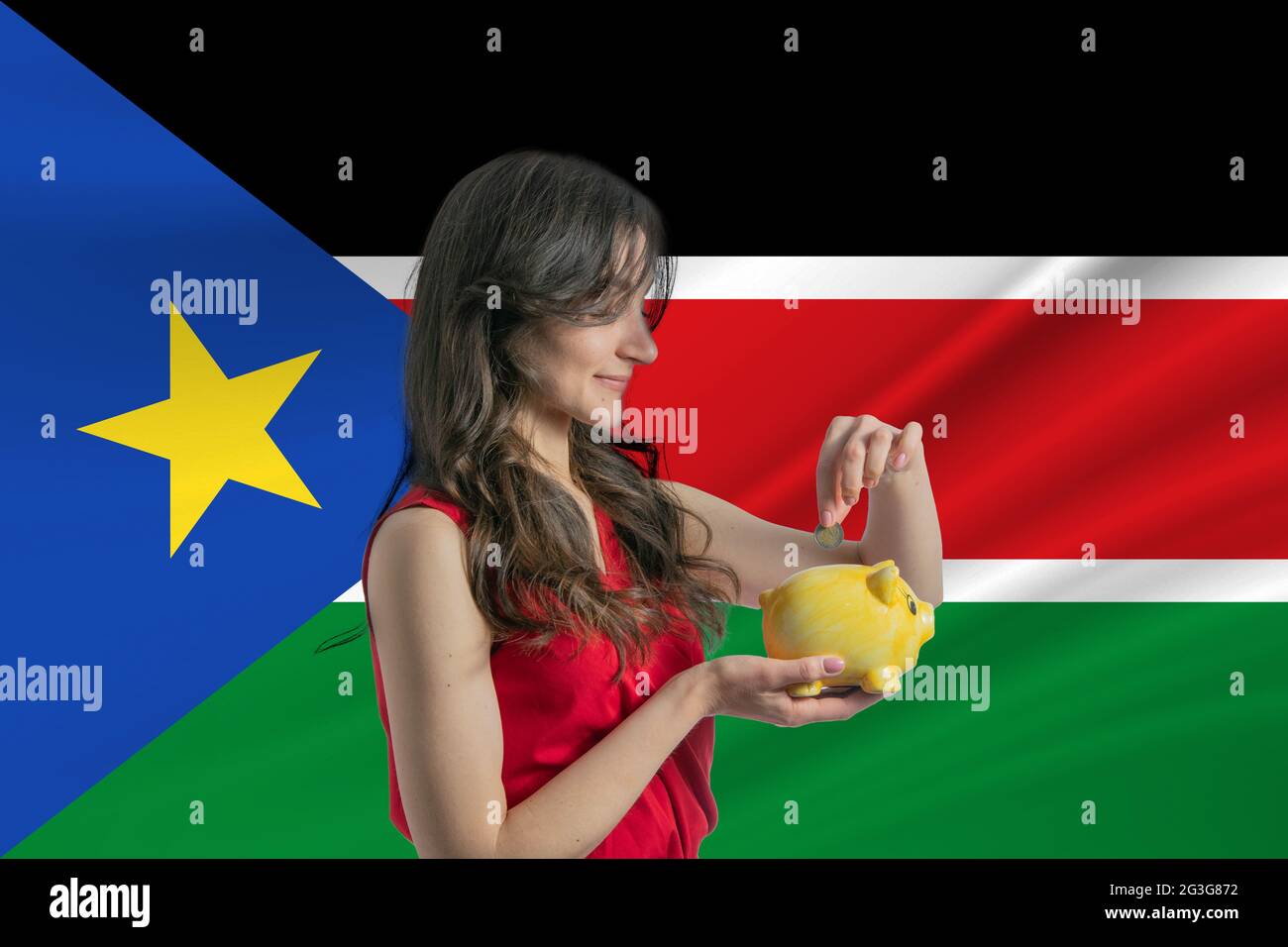 Economy in South Sudan. Accumulating and saving money in South Sudan. Woman putting money coin in piggy bank for saving money and plan finance Stock Photo