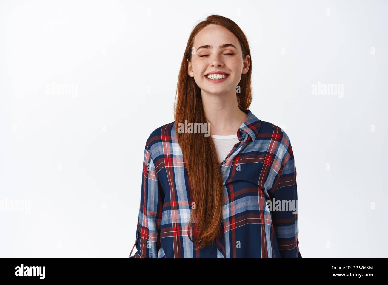 People and lifestyle. Happy beautiful redhead girl with long natural hair, freckles and no make up, dreaming of something, imaging and smiling with Stock Photo