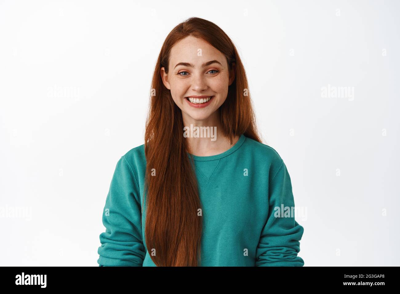 Portrait of young girl with red long hair, smiling white teeth, looking ...