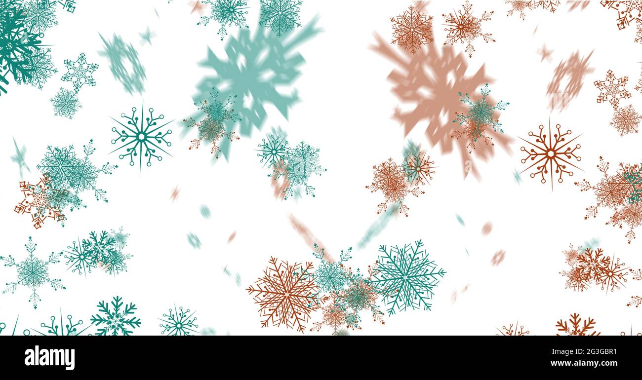 Digitally generated image of green and red snowflakes against white
