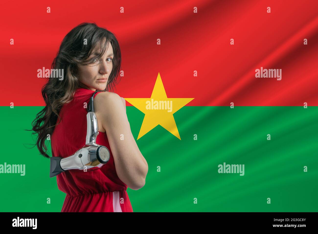 Beauty industry in Burkina Faso. Happy female hairdresser holding