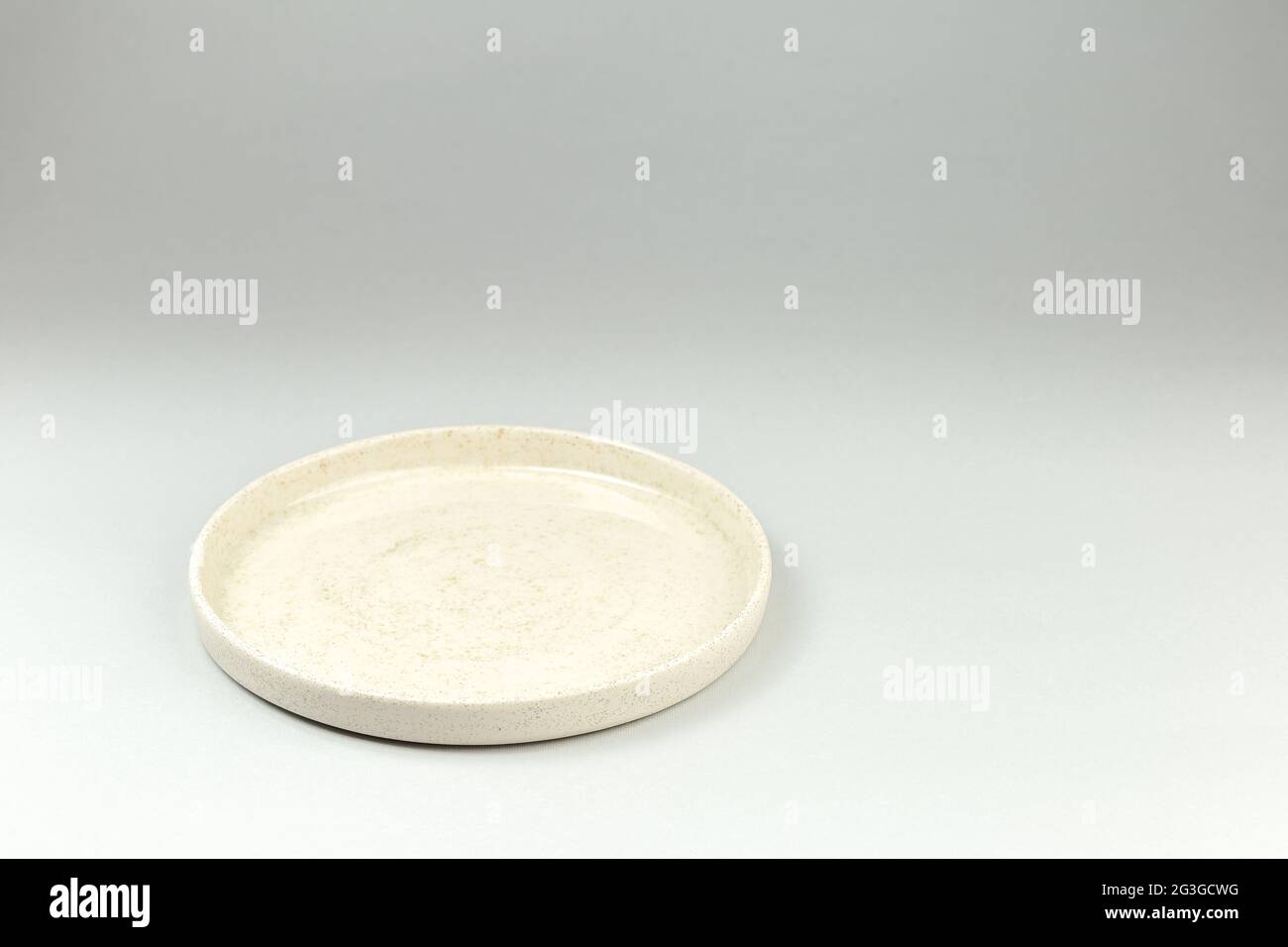 Empty White Ceramic Plate with High Borders on gray background Stock Photo