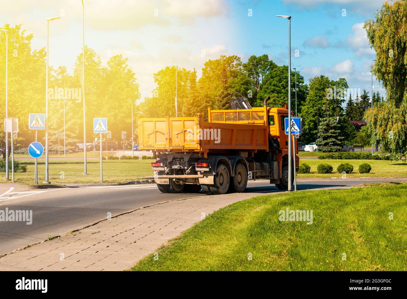 Heavy industrial dump truck maneuvering in the narrow pass of a