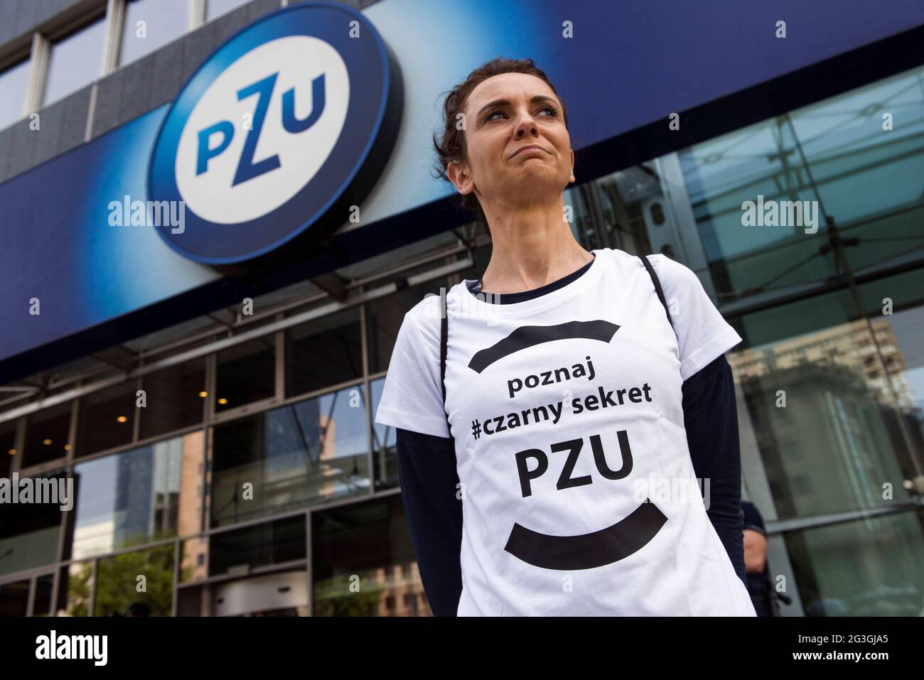 Warsaw, Poland, 16/06/2021, An activist is wearing a t-shirt that read  "learn the black secret of PZU" during the protest outside the PZU  headquarters.Eco activists protested outside the headquarter of PZU in