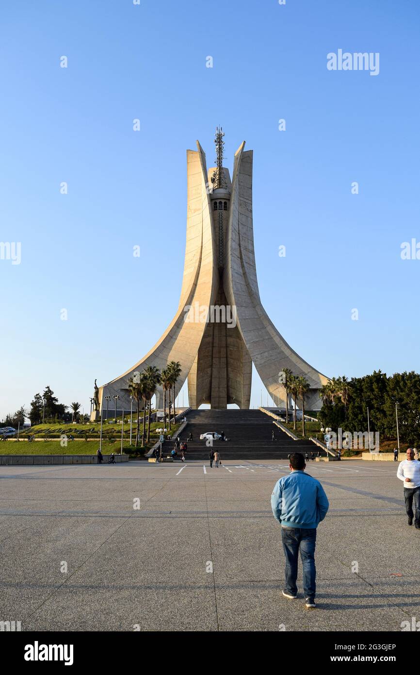 Rear view of a young man walking to Maqam Echahid monument, Martyrs Monument, Memorial statue. Stock Photo