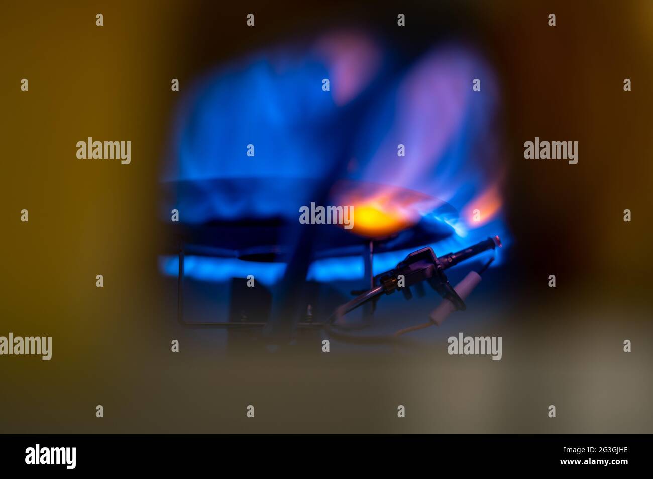 Pilot light auto igniter inside a hot water heater with flames Stock