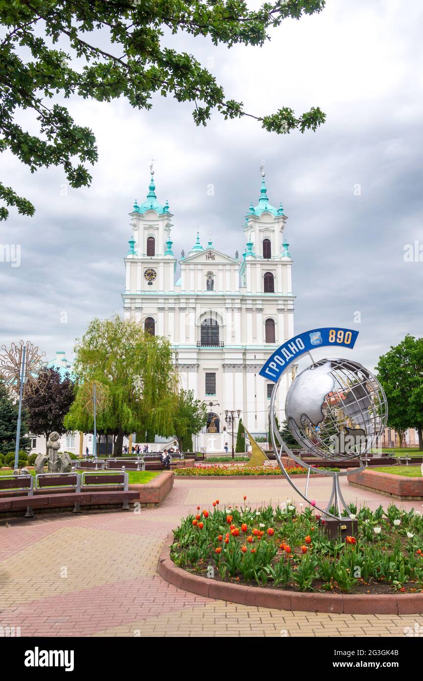 GRODNO, BELARUS - MAY 22, 2021: Cathedral of Saint Francis Xavier in Grodno, Belarus. Farny Catholic church facade and sign Grodno 890 on silver globe Stock Photo