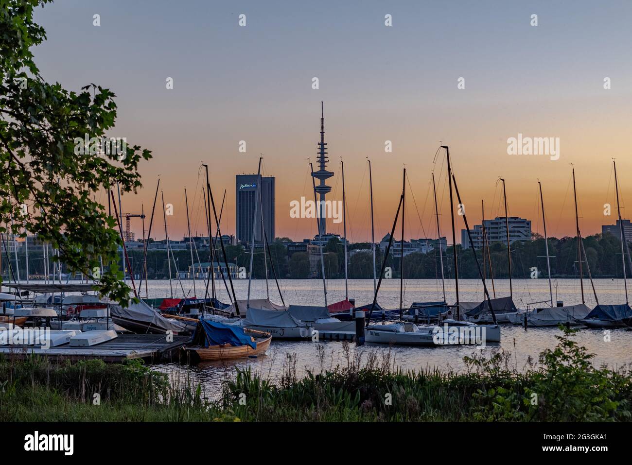 Hamburg Außenalster with sailing boats and the Radisson Blu Hotel and the Heinrich Hertz tower Stock Photo