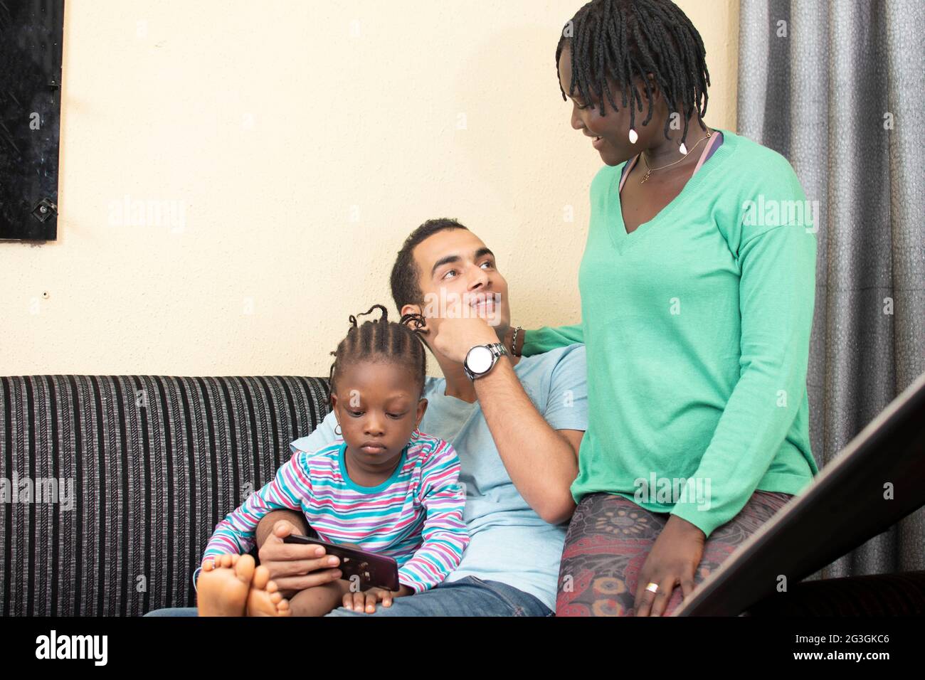 interracial family sitting on the couch Stock Photo