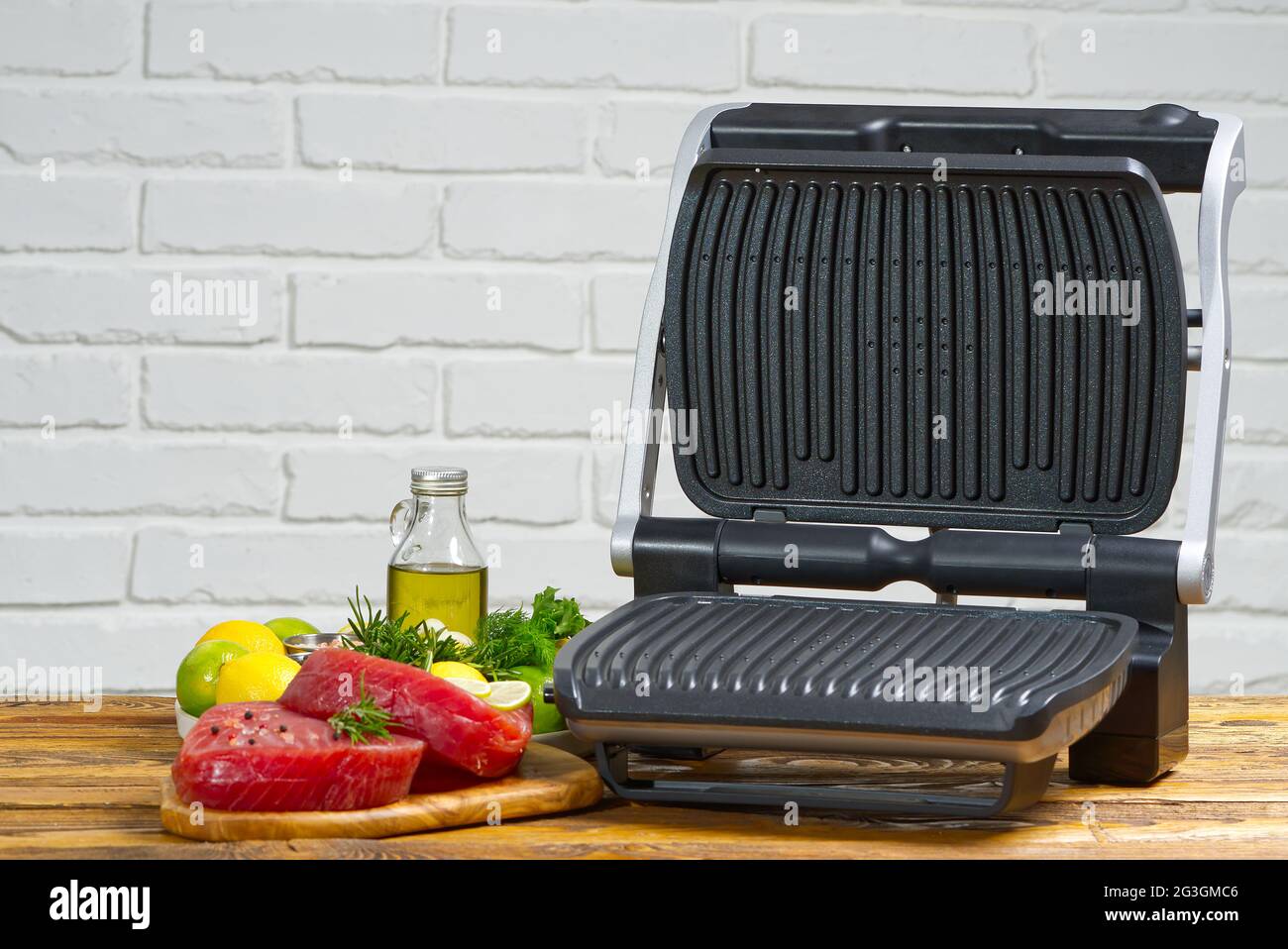raw tuna steaks cooking on electric grill Stock Photo Alamy
