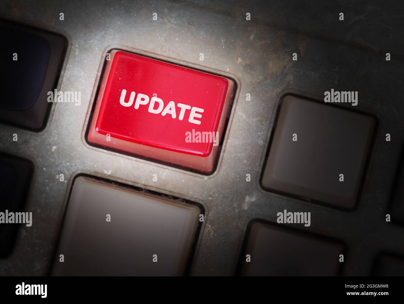 Red button on a dirty old panel Stock Photo