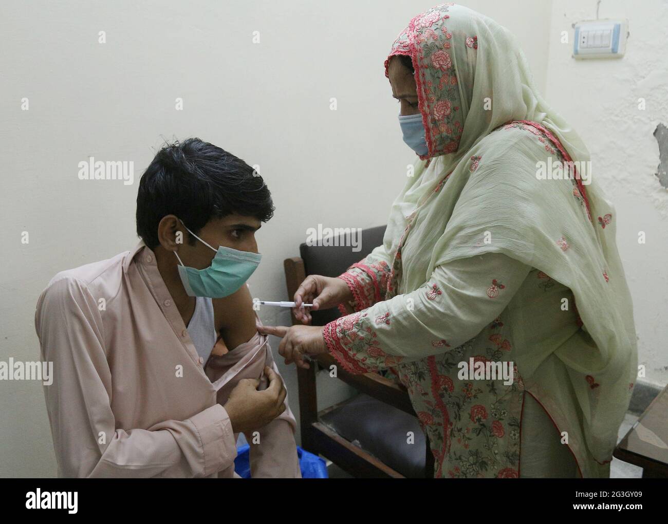 Hyderabad, Pakistan. 15th June, 2021. A health worker is injecting the