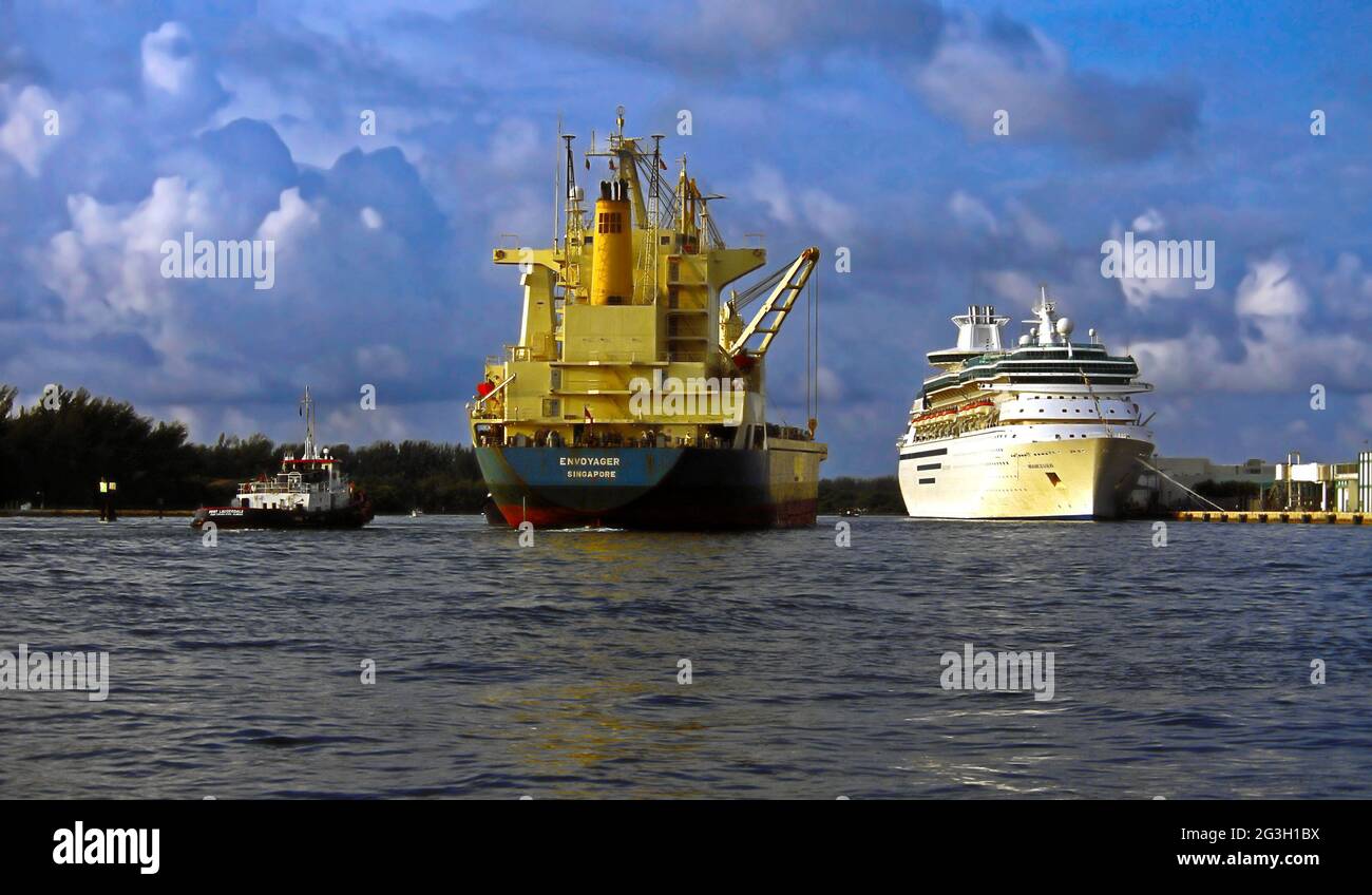 tug boat guiding freighter, cruise ship docked; shipping; port, transportation, boats, industry, Fort Lauderdale; FL; Florida, USA Stock Photo